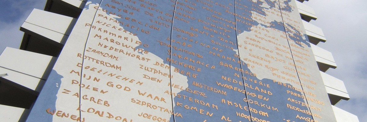 Artwork Marieken Verheyen on Bijlmerflat Amsterdam, continents as mural, meridians milled in neon and text