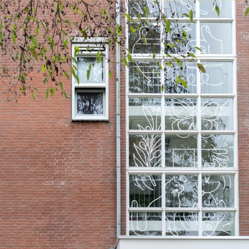 Illustrations by artist Gino Bud Hoiting in foil on windows of houses Almere